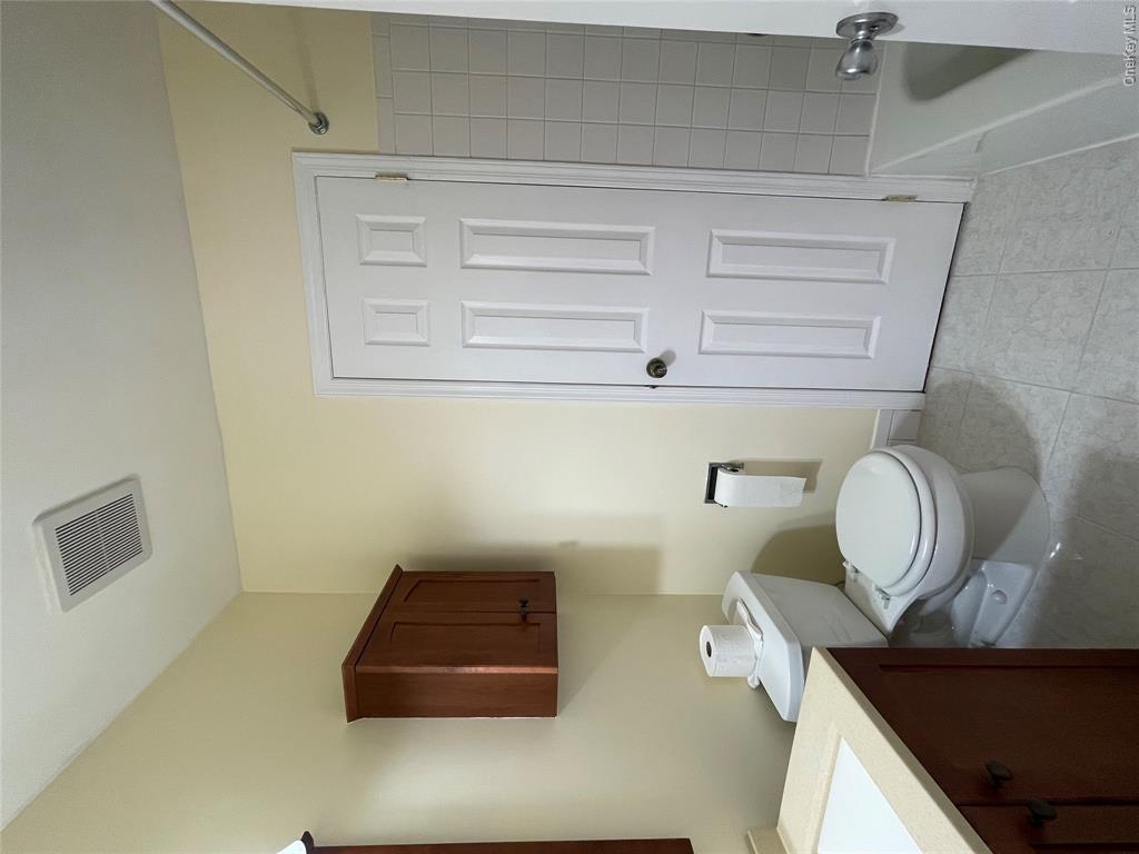 4 Cornwallis Road East Setauket, NY 11733 - Photo 6 of 16 a white toilet sitting next to a bathroom sink