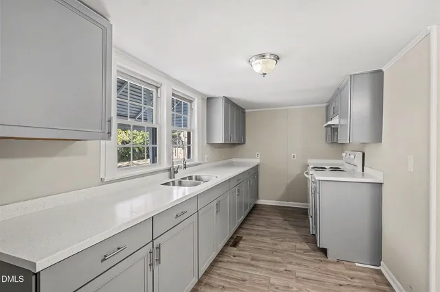 a large white kitchen with a large window