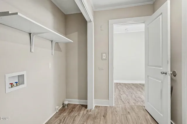 a view of a hallway with wooden floor and entryway