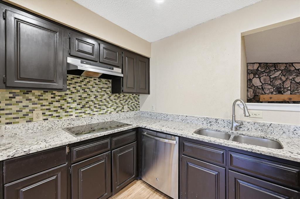 1503 North Fielder Road Arlington, TX 76012 - Photo 13 of 40 a kitchen with granite countertop a sink and cabinets