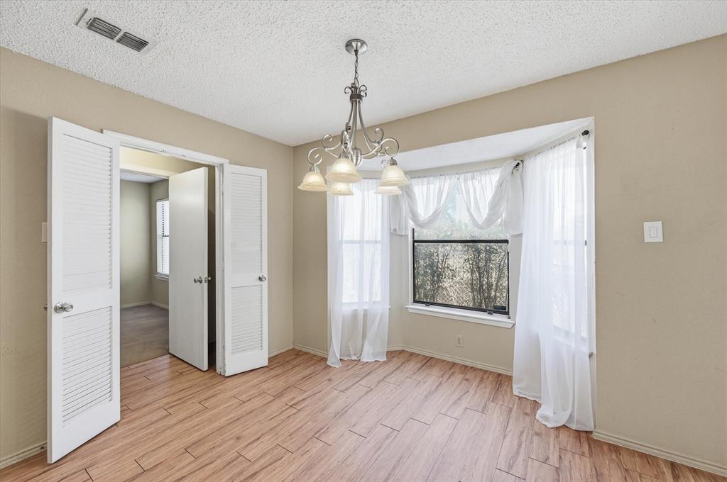 1503 North Fielder Road Arlington, TX 76012 - Photo 14 of 40 wooden floor in an empty room with a window