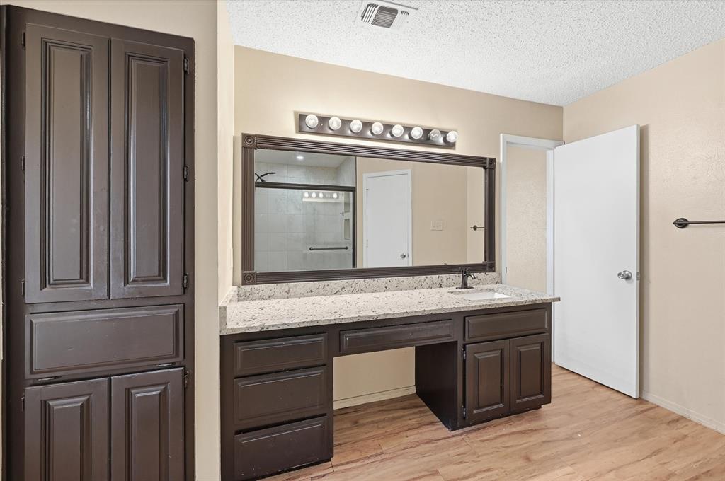 1503 North Fielder Road Arlington, TX 76012 - Photo 20 of 40 a bathroom with a granite countertop sink and a mirror