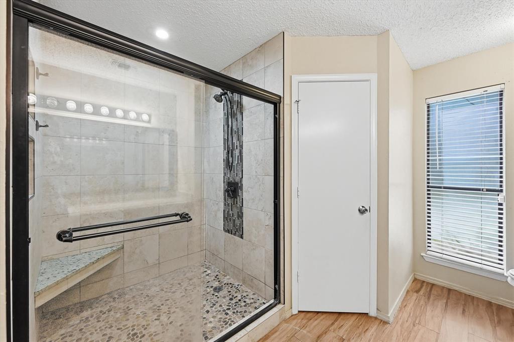 1503 North Fielder Road Arlington, TX 76012 - Photo 21 of 40 a bathroom with a glass shower door