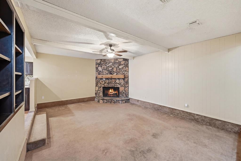 1503 North Fielder Road Arlington, TX 76012 - Photo 4 of 40 an empty room with a fireplace and chandelier