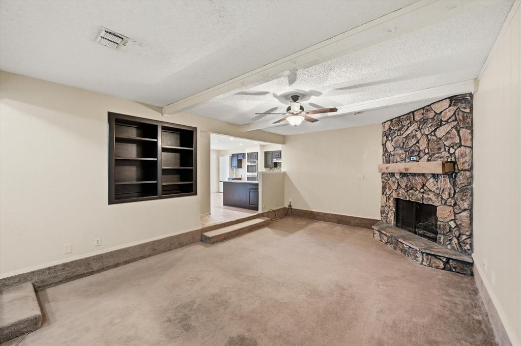 1503 North Fielder Road Arlington, TX 76012 - Photo 5 of 40 a view of an empty room with a fireplace and a window