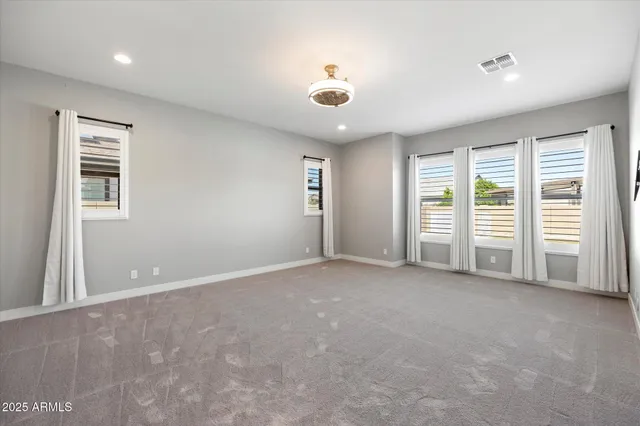 an empty room with a empty space and windows