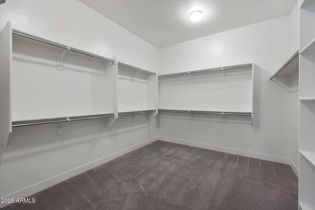 a view of a big room with wooden floor and windows