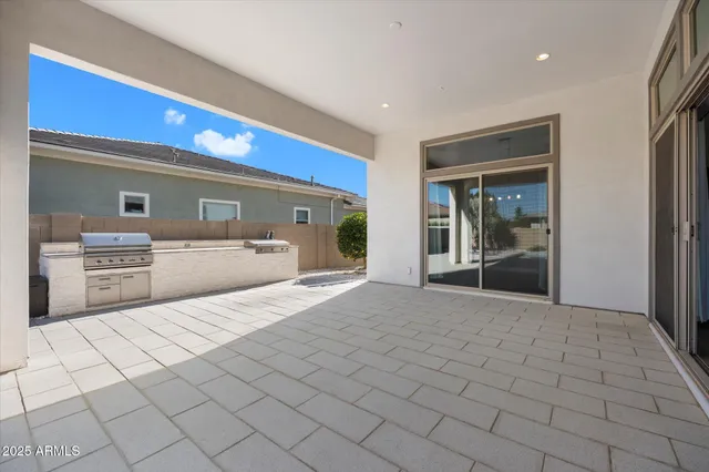 a view of a house with pool and chairs
