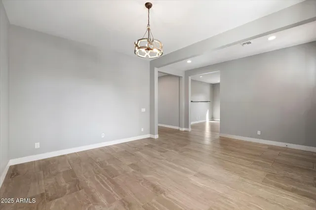 a view of a room with wooden floor and ceiling fan