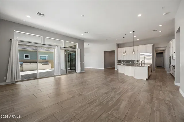 a view of kitchen with cabinets and refrigerator