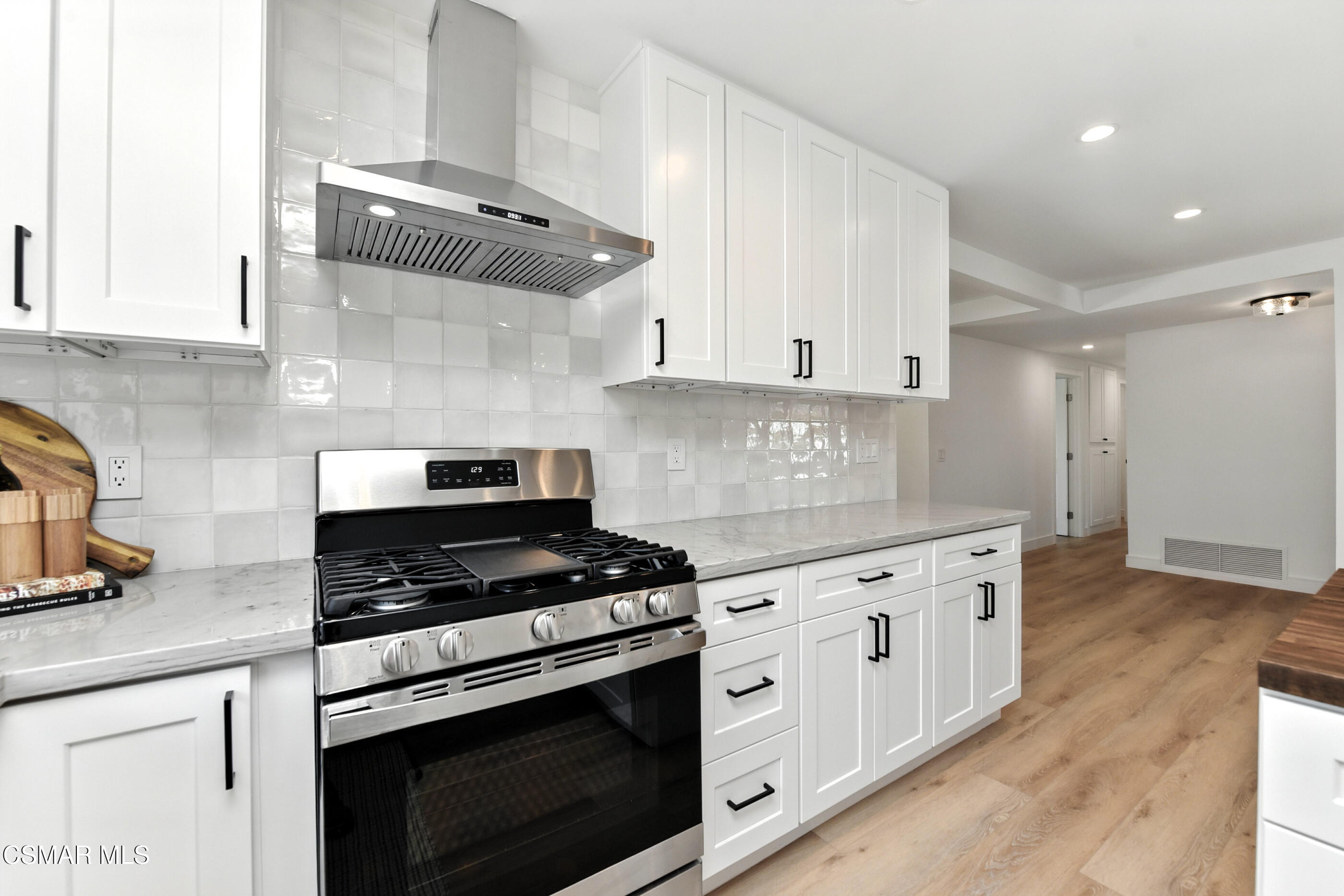 6669 Charing Street Simi Valley, CA 93063 - Photo 13 of 52 a kitchen with granite countertop white cabinets and white appliances