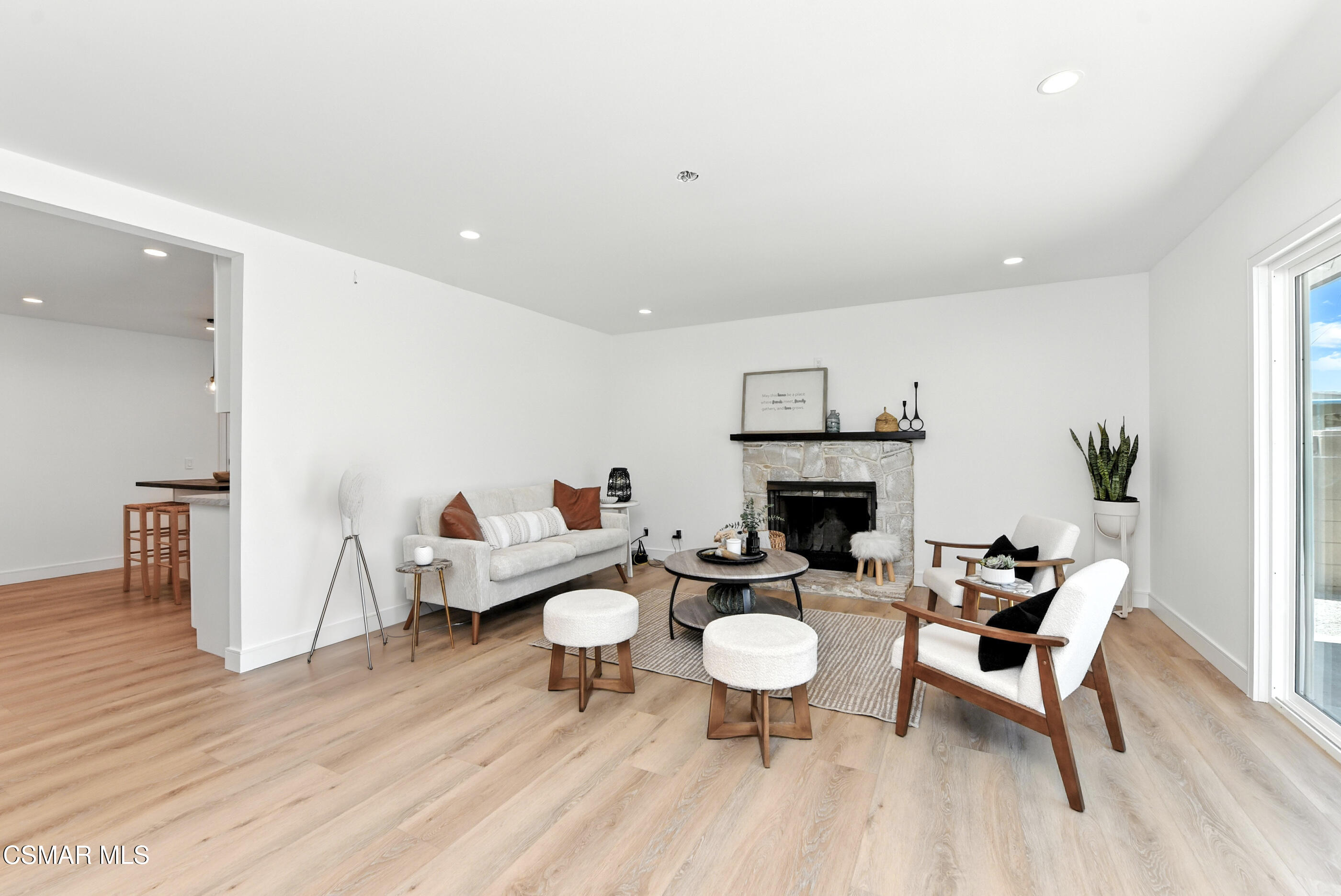6669 Charing Street Simi Valley, CA 93063 - Photo 17 of 52 a living room with furniture a fireplace and a table
