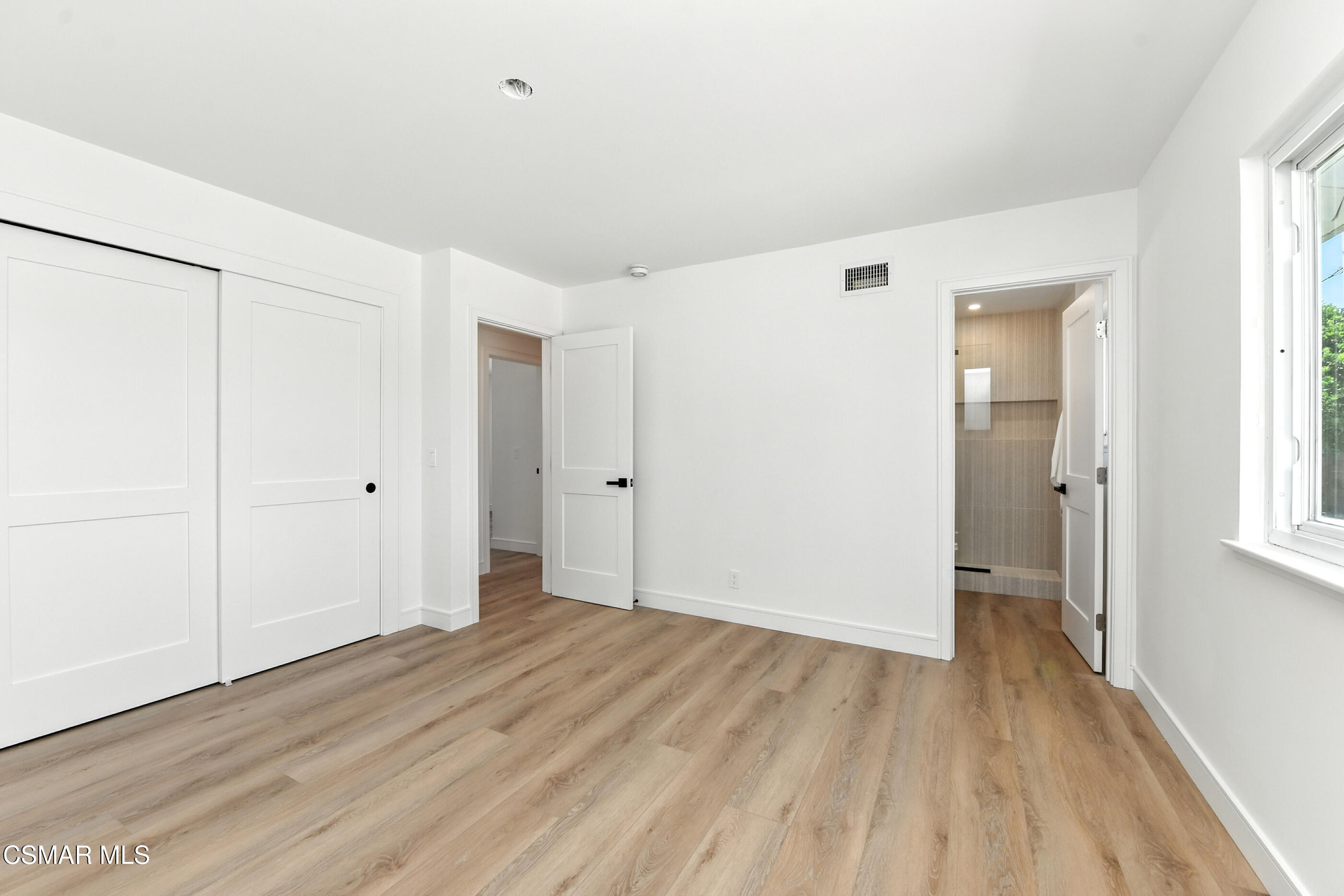 6669 Charing Street Simi Valley, CA 93063 - Photo 29 of 52 a view of an empty room with wooden floor