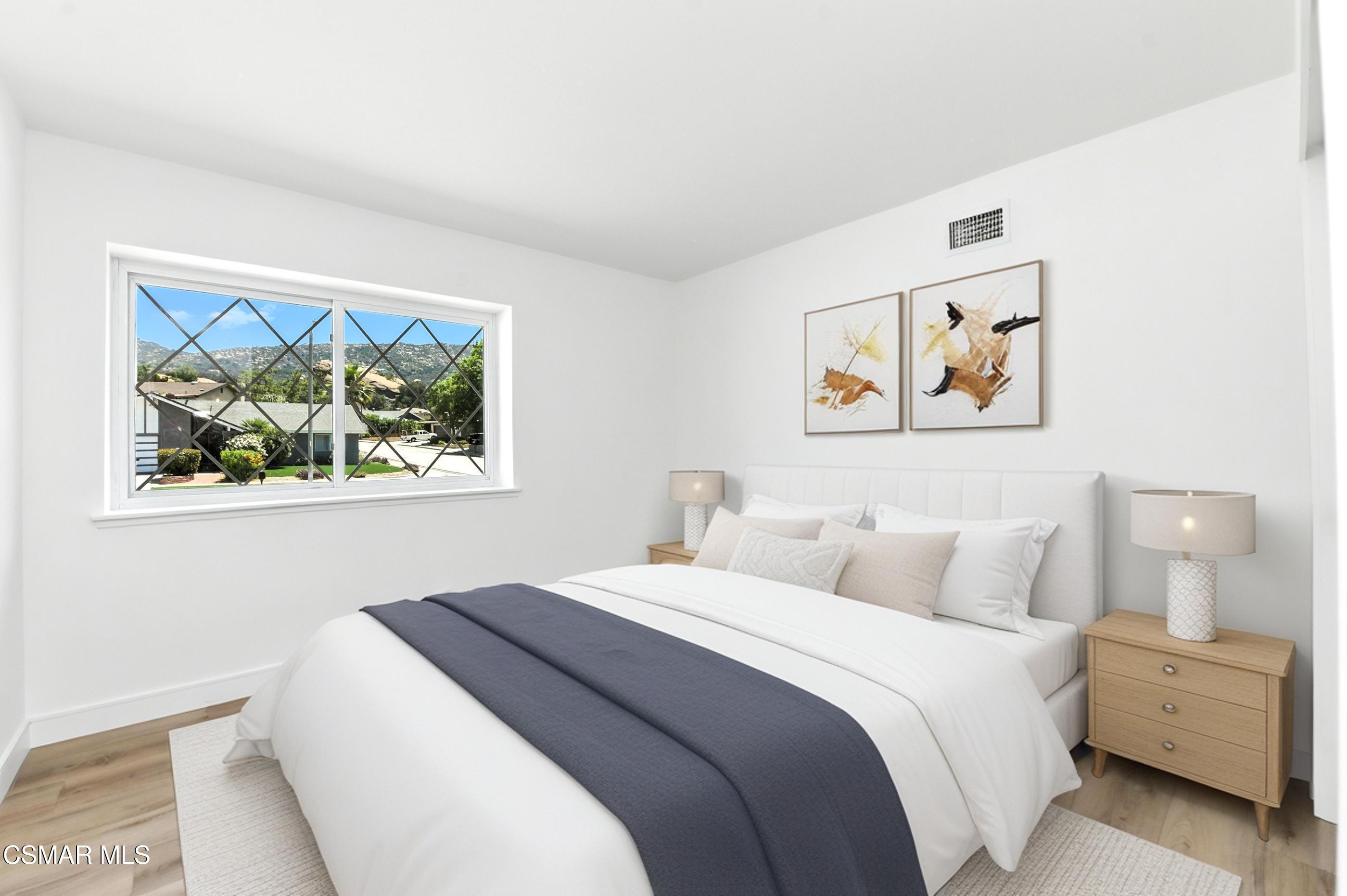 6669 Charing Street Simi Valley, CA 93063 - Photo 34 of 52 a bedroom with a bed and painting on the wall