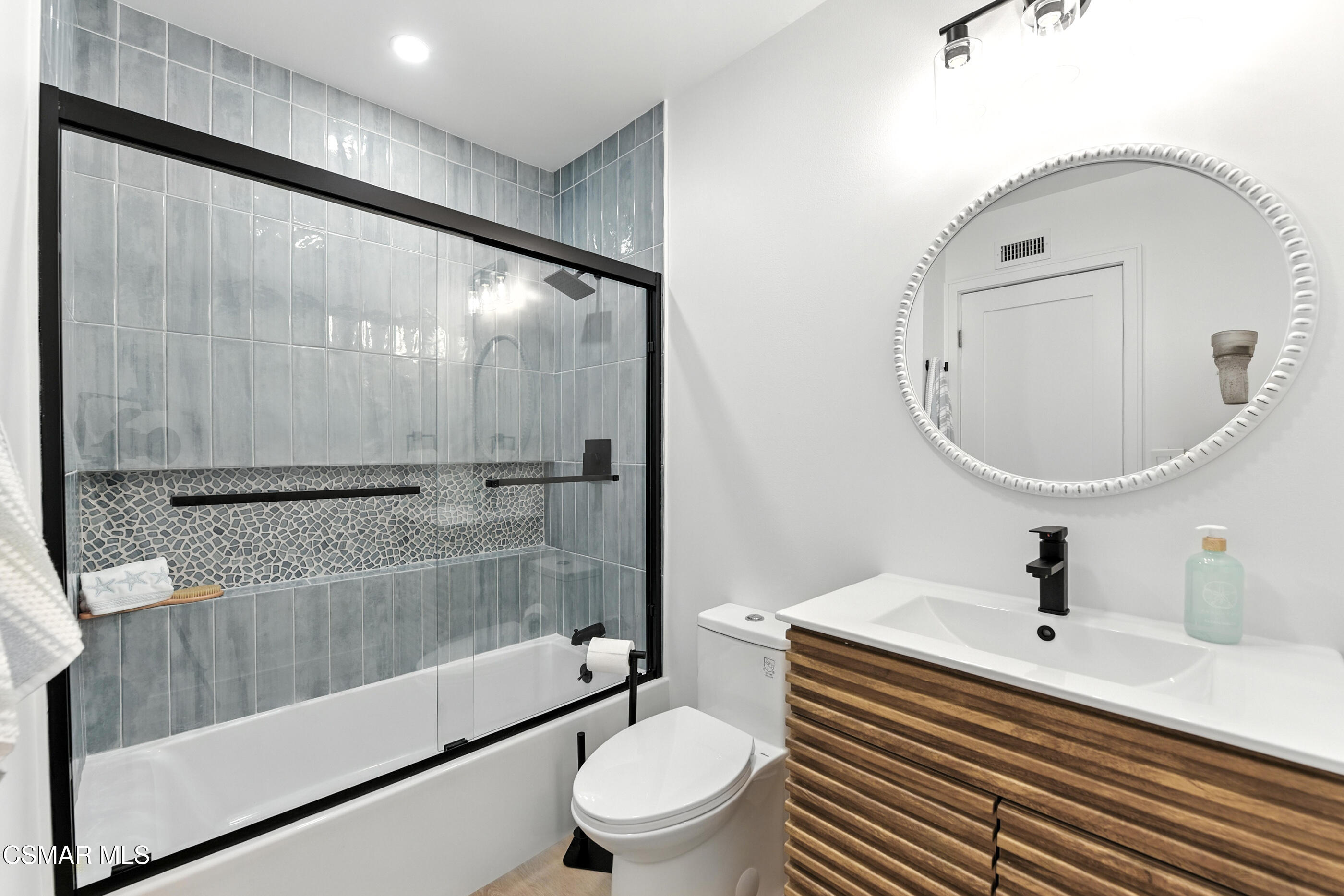 6669 Charing Street Simi Valley, CA 93063 - Photo 40 of 52 a bathroom with a sink a toilet and a mirror