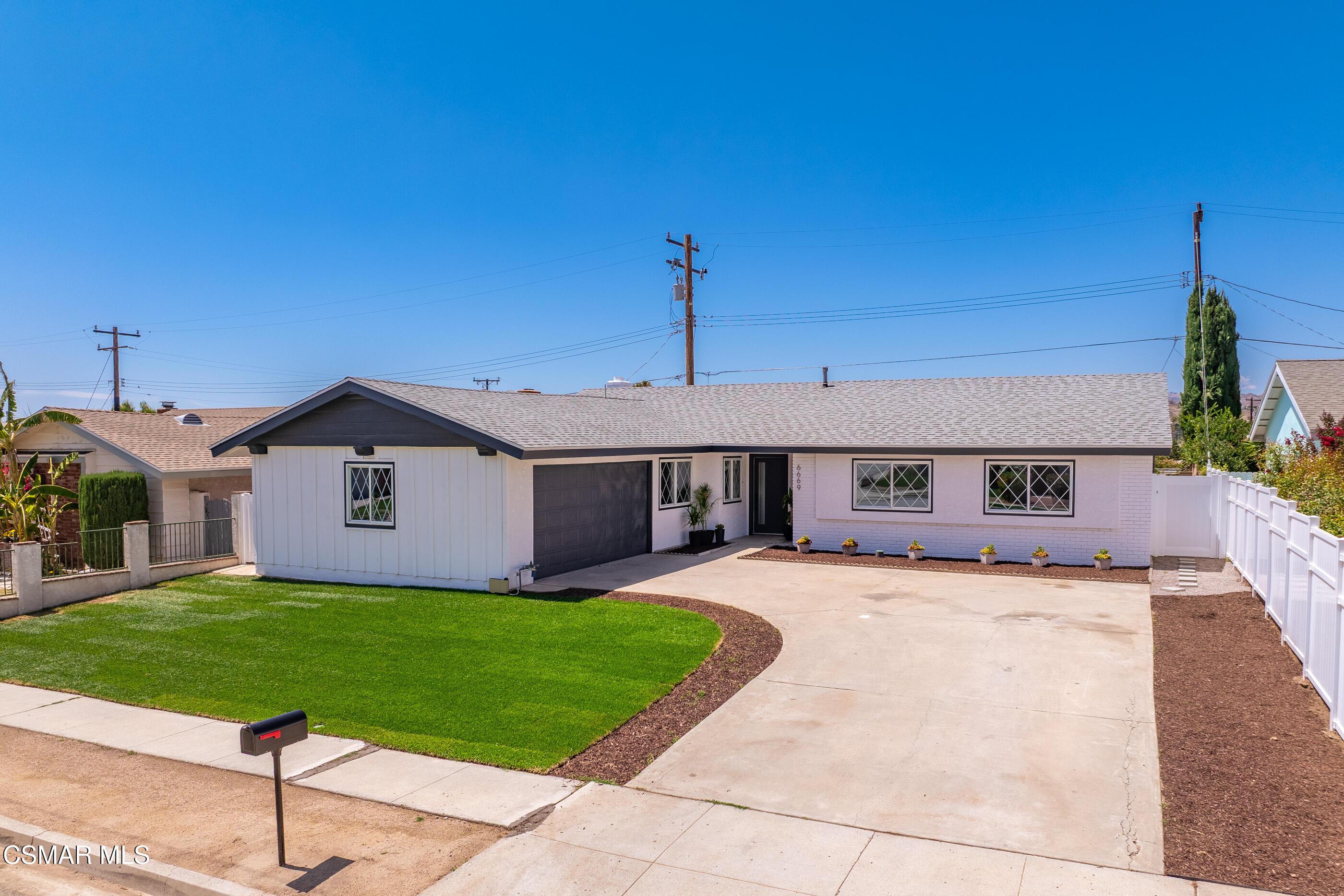 6669 Charing Street Simi Valley, CA 93063 - Photo 47 of 52 a front view of a house with a yard and garage