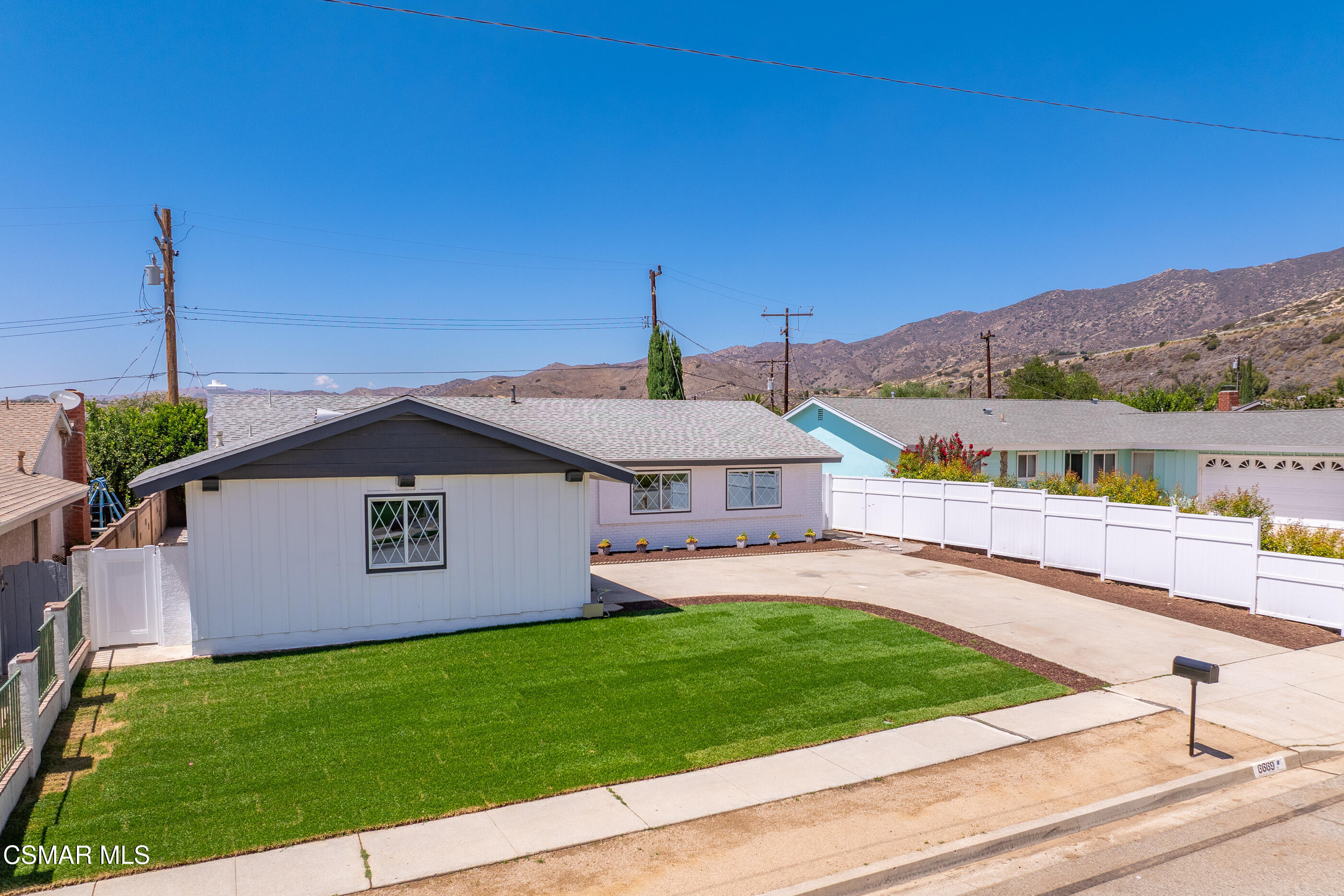 6669 Charing Street Simi Valley, CA 93063 - Photo 49 of 52 a front view of a house with a garden and yard