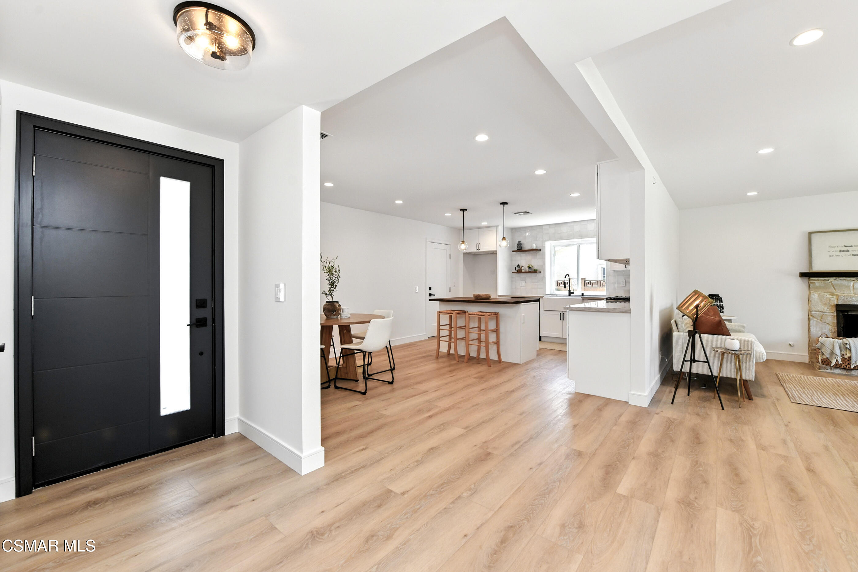 6669 Charing Street Simi Valley, CA 93063 - Photo 5 of 52 a living room with stainless steel appliances kitchen island granite countertop furniture and a fireplace
