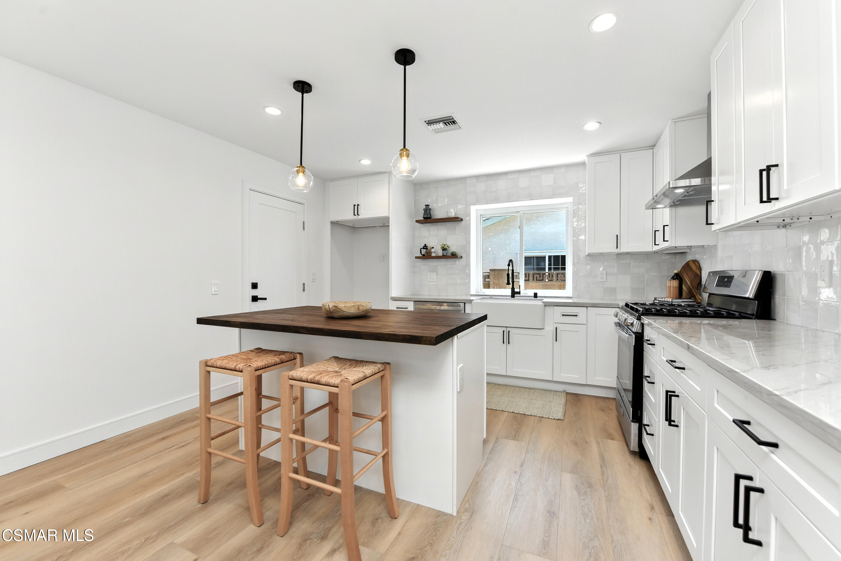6669 Charing Street Simi Valley, CA 93063 - Photo 8 of 52 a kitchen with granite countertop a sink cabinets and wooden floor