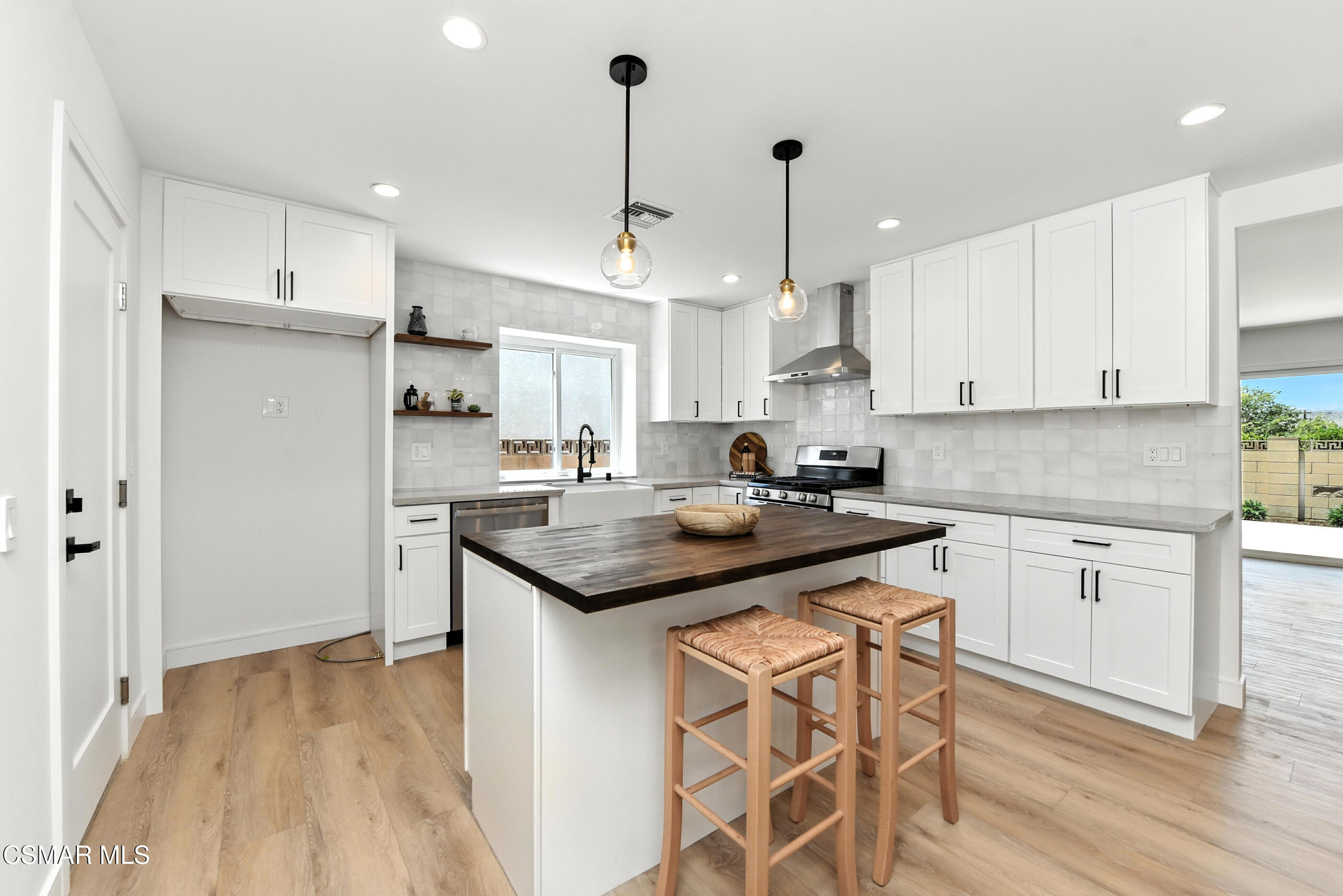 6669 Charing Street Simi Valley, CA 93063 - Photo 9 of 52 a kitchen with stainless steel appliances kitchen island granite countertop a sink and cabinets