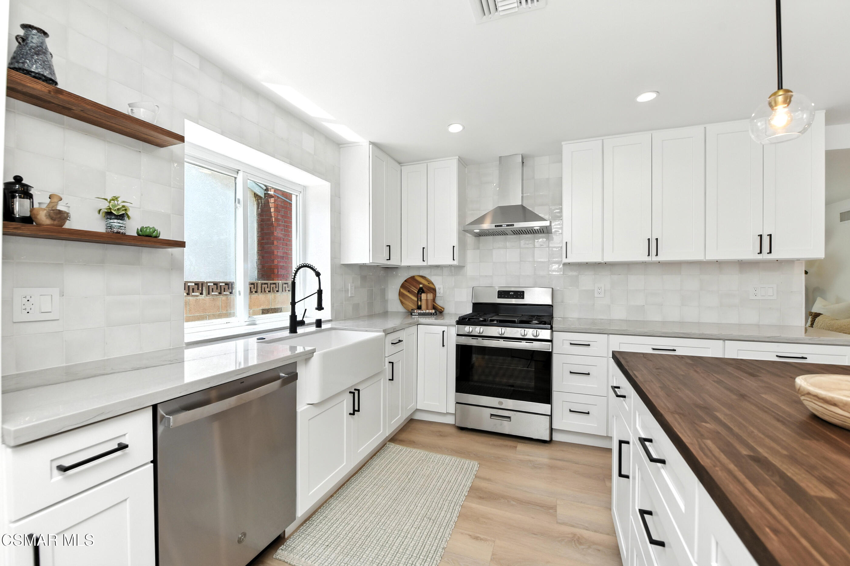 6669 Charing Street Simi Valley, CA 93063 - Photo 10 of 52 a kitchen with stainless steel appliances granite countertop a sink stove and cabinets