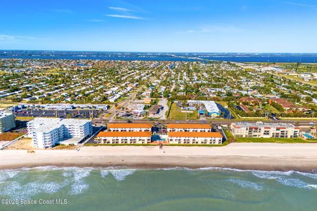 a view of an apartment with a backyard