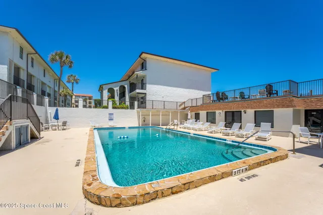 a view of a balcony with wooden floor and outdoor seating