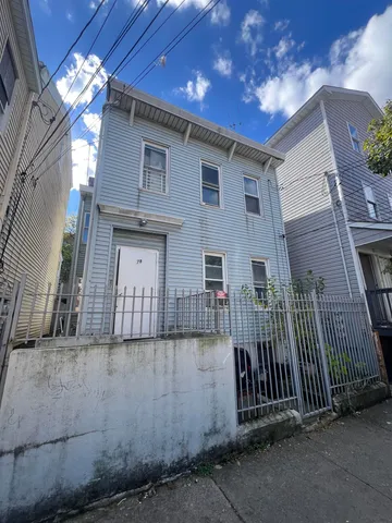 a view of a house with a door and wooden fence