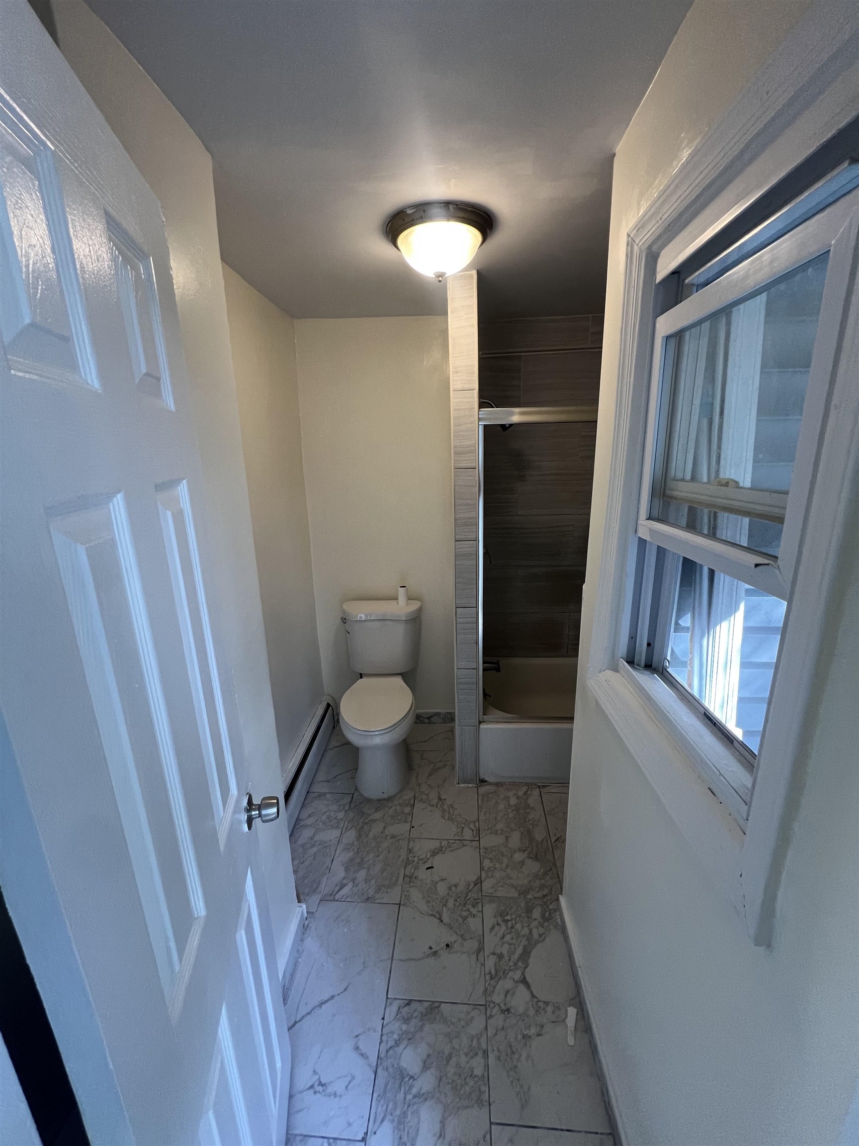 78 16th Avenue, Unit 2 Paterson, NJ 07501 - Photo 8 of 9 a bathroom with a sink and toilet