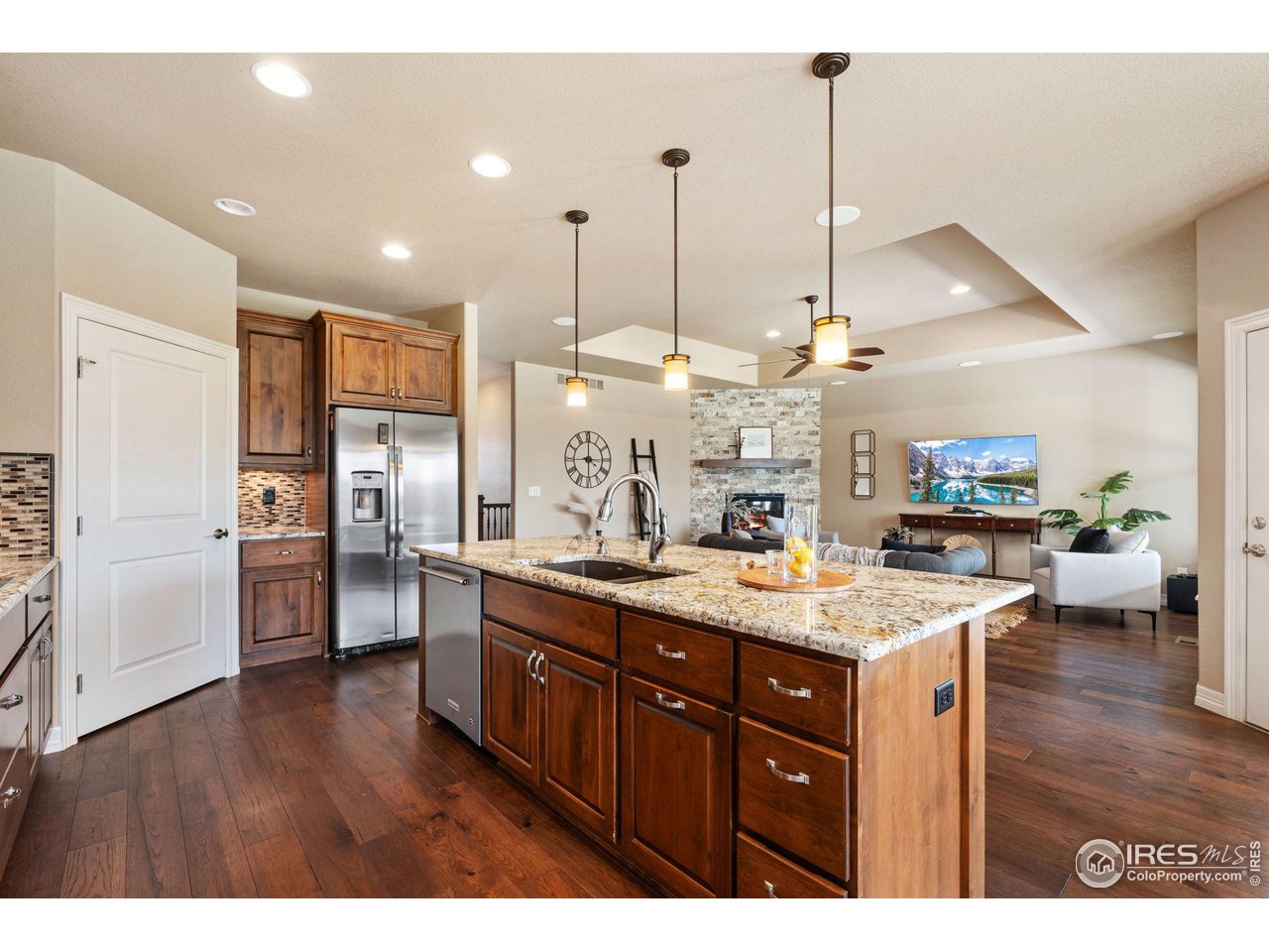 6740 Olympia Fields Court Windsor, CO 80550 - Photo 10 of 28 a kitchen with a sink a counter top appliances and cabinets