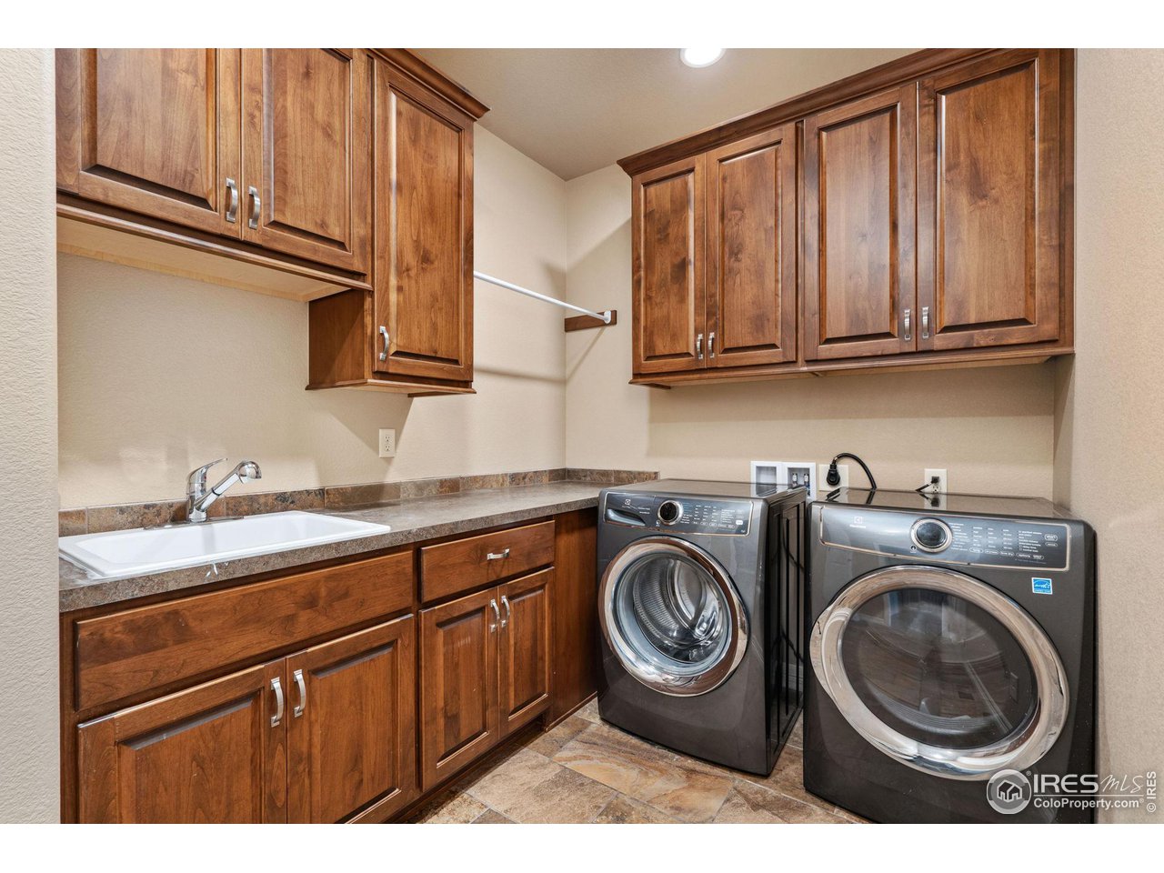 6740 Olympia Fields Court Windsor, CO 80550 - Photo 17 of 28 a kitchen with a sink a stove and cabinets
