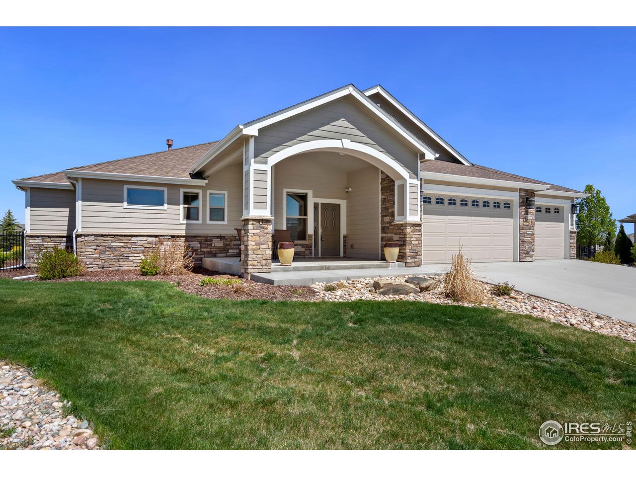 6740 Olympia Fields Court Windsor, CO 80550 - Photo 2 of 28 a front view of a house with a yard
