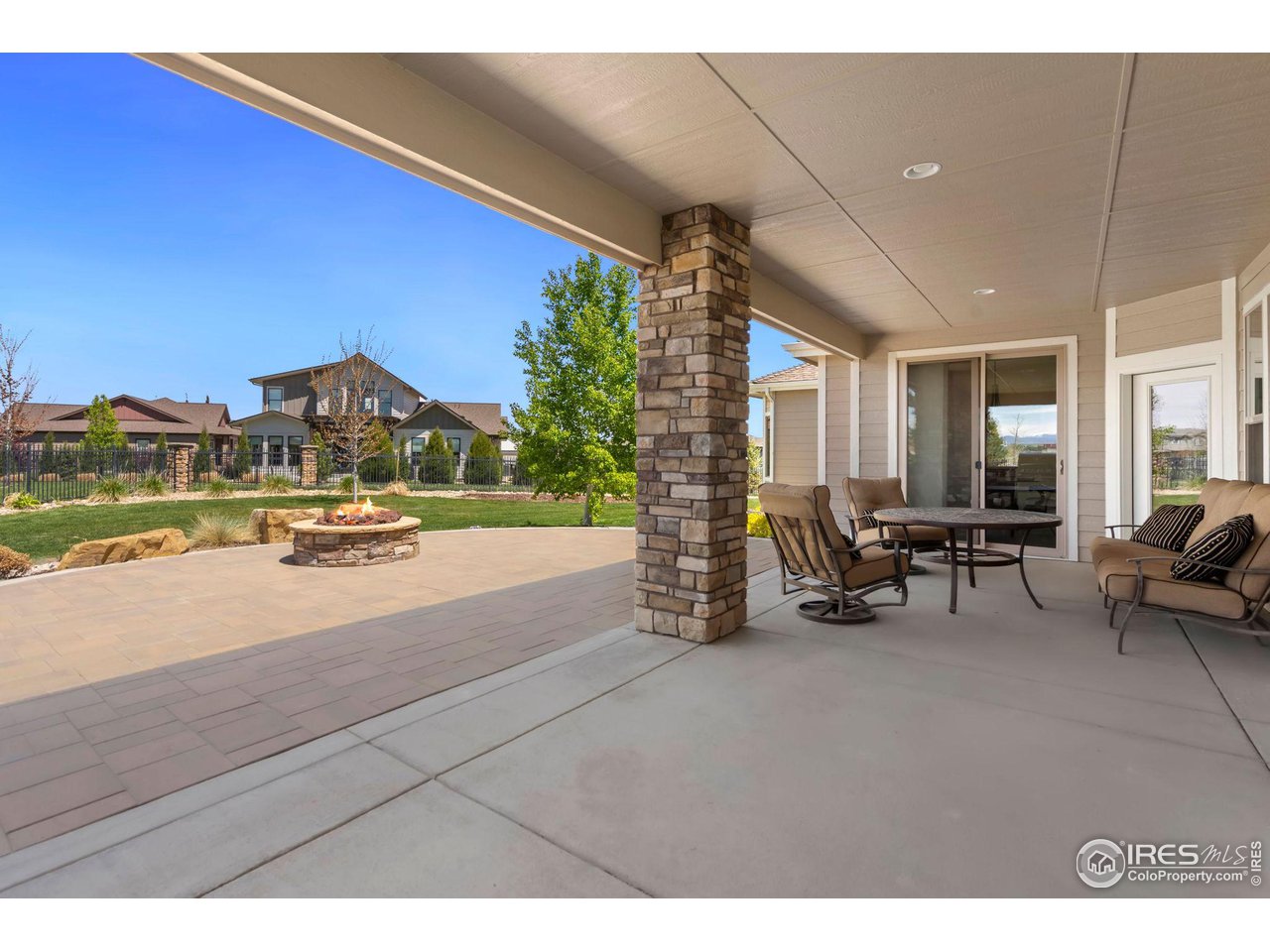 6740 Olympia Fields Court Windsor, CO 80550 - Photo 20 of 28 a view of a patio with table and chairs