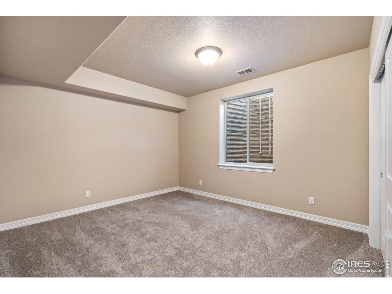 6740 Olympia Fields Court Windsor, CO 80550 - Photo 25 of 28 a view of an empty room with a window