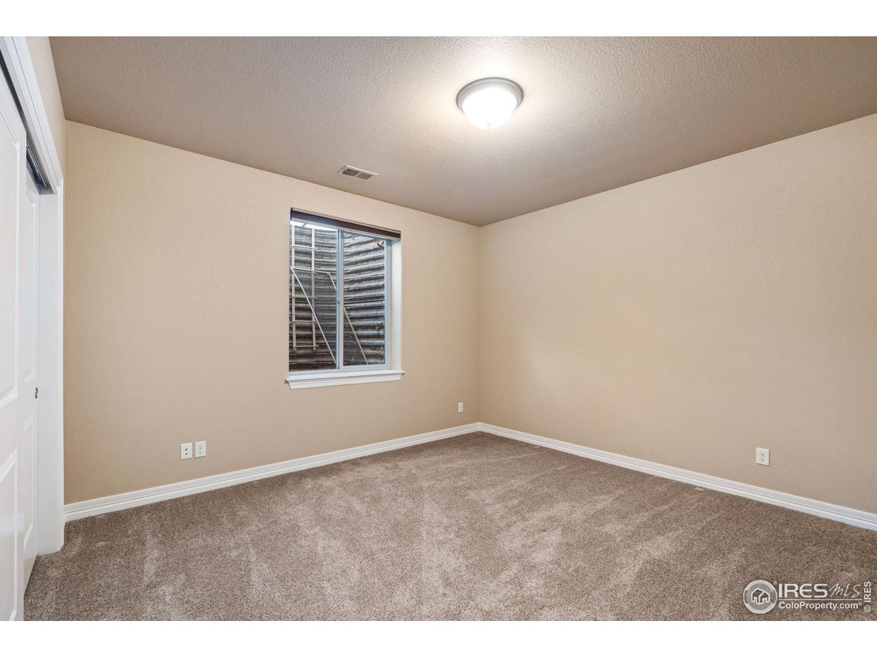 6740 Olympia Fields Court Windsor, CO 80550 - Photo 26 of 28 a view of an empty room with a window