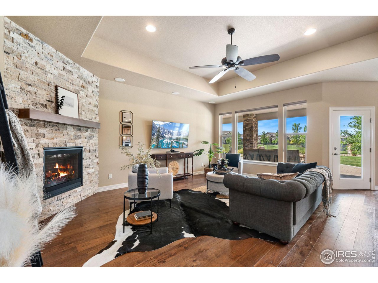 6740 Olympia Fields Court Windsor, CO 80550 - Photo 4 of 28 a living room with furniture and a fireplace