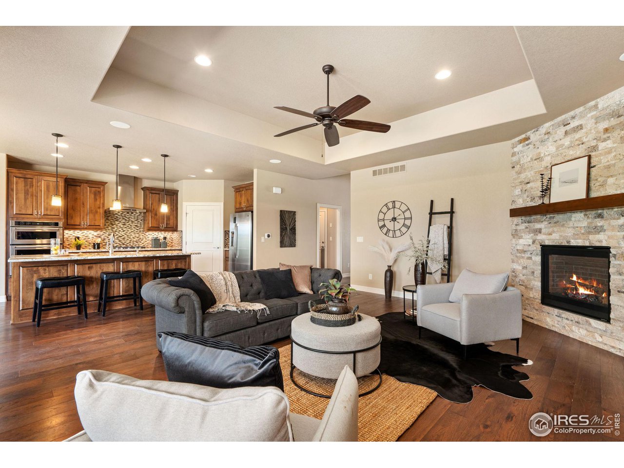 6740 Olympia Fields Court Windsor, CO 80550 - Photo 5 of 28 a living room with furniture and a fireplace