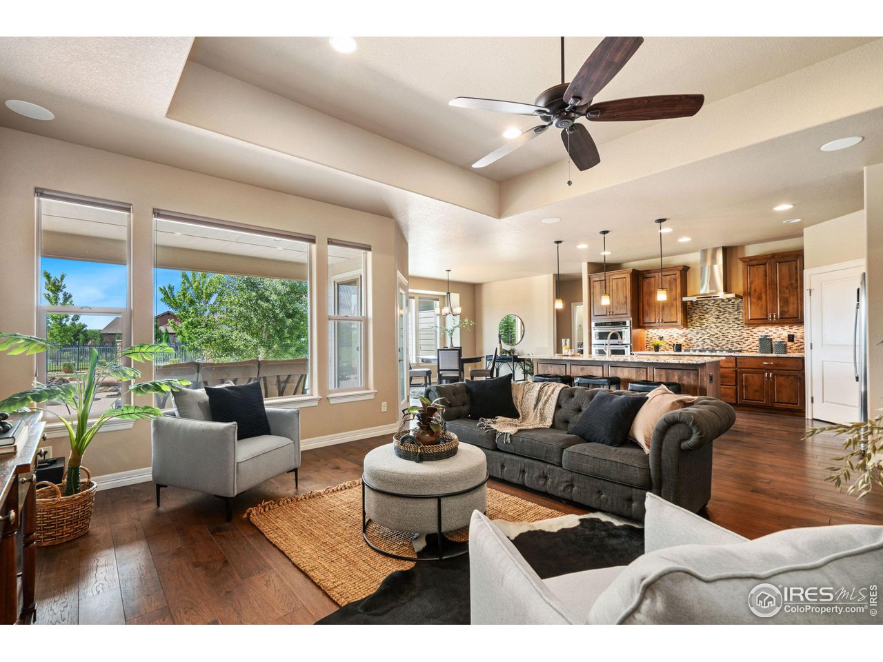 6740 Olympia Fields Court Windsor, CO 80550 - Photo 28 of 28 a living room with furniture and a large window