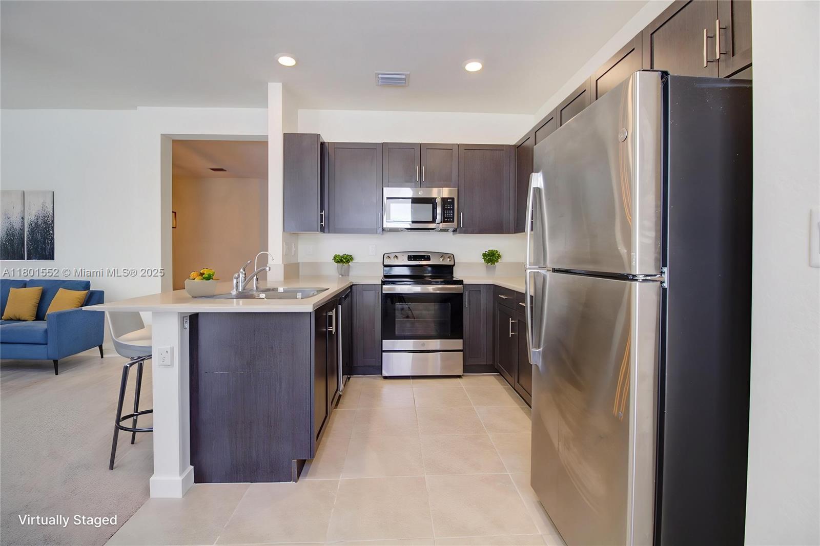11094 West 33rd Way Hialeah, FL 33018 - Photo 14 of 46 a kitchen with stainless steel appliances granite countertop a refrigerator a stove a sink and a refrigerator