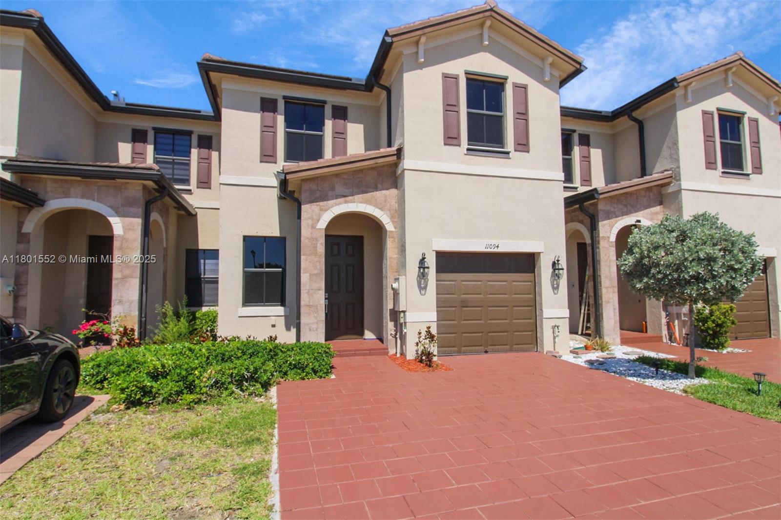 11094 West 33rd Way Hialeah, FL 33018 - Photo 2 of 46 a front view of a house with a yard