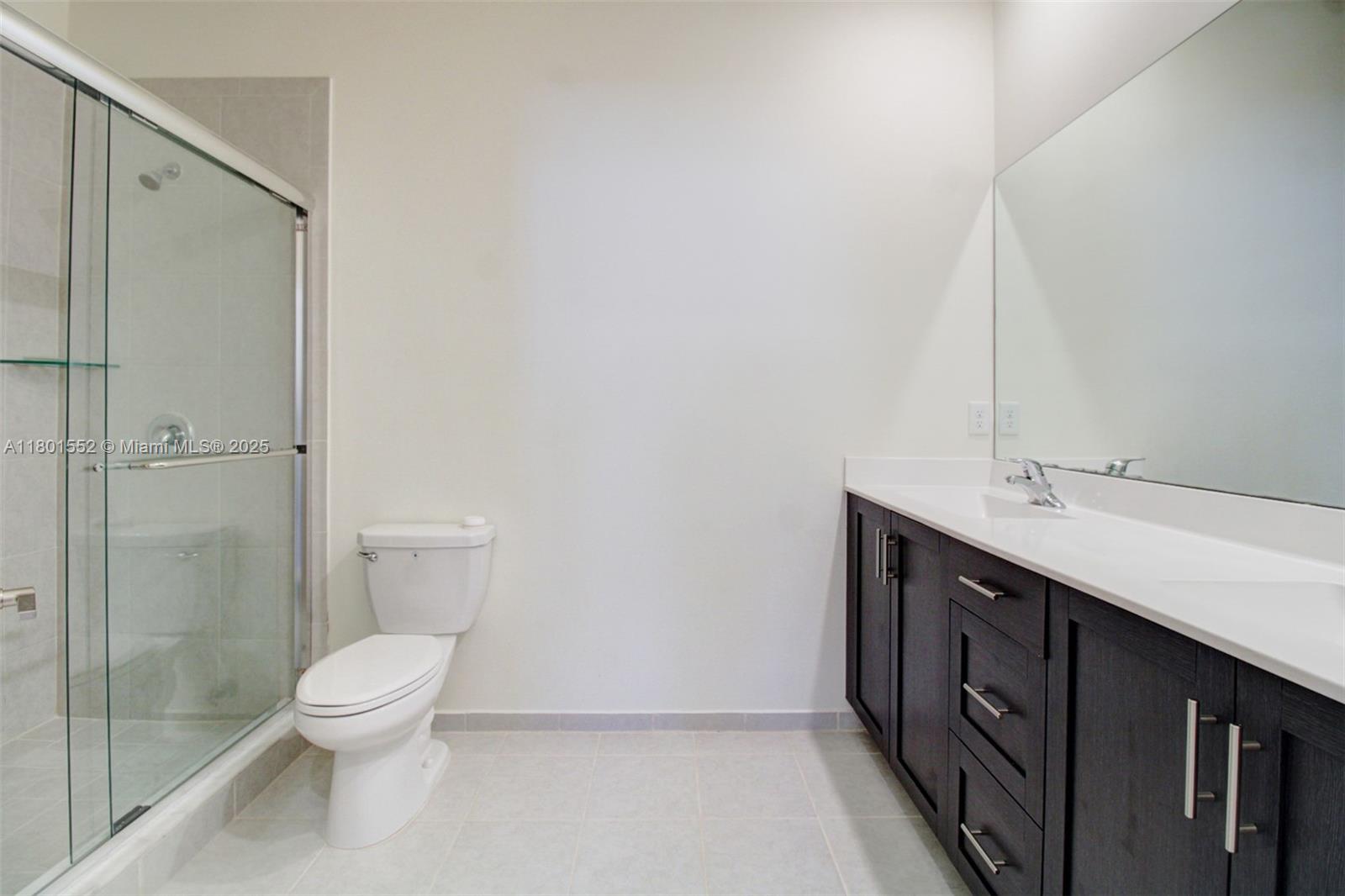 11094 West 33rd Way Hialeah, FL 33018 - Photo 23 of 46 a bathroom with a double vanity sink toilet and shower