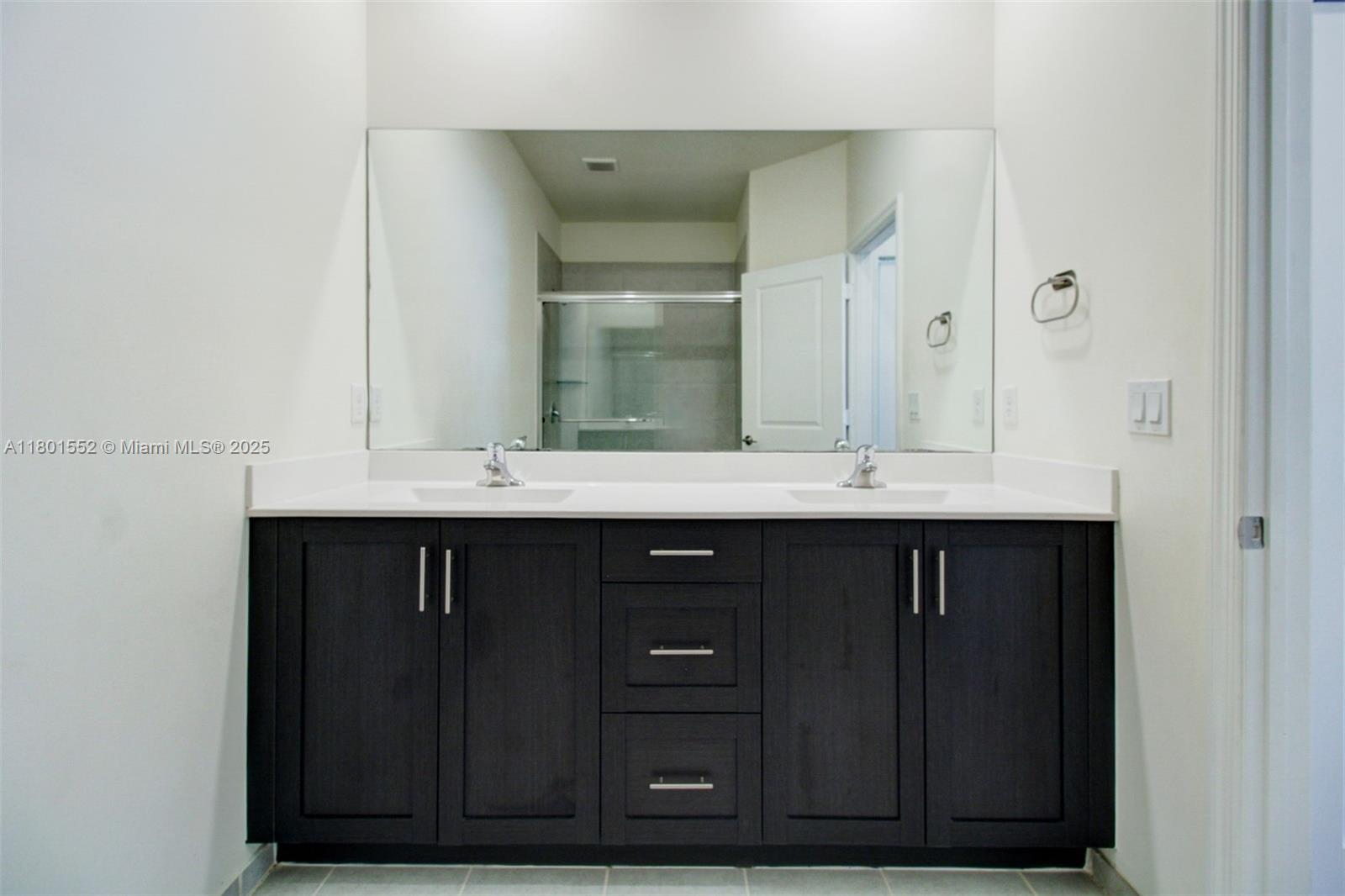 11094 West 33rd Way Hialeah, FL 33018 - Photo 24 of 46 a bathroom with a sink vanity and mirror