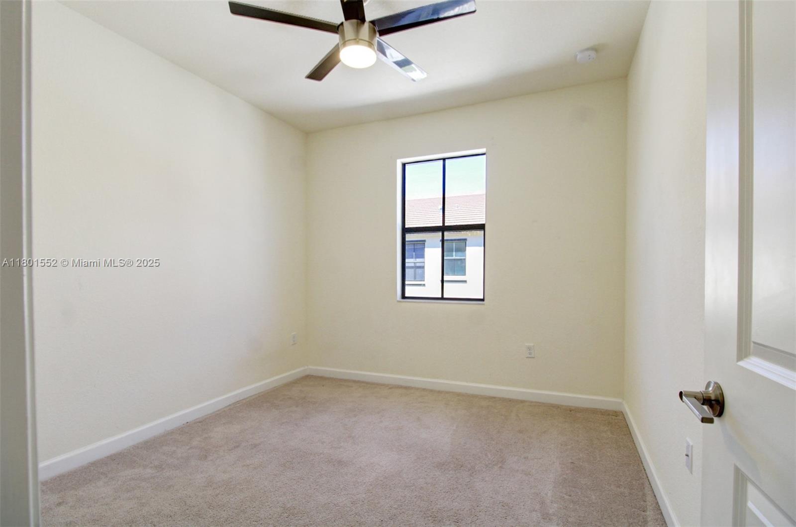 11094 West 33rd Way Hialeah, FL 33018 - Photo 29 of 46 an empty room with a window and a fan