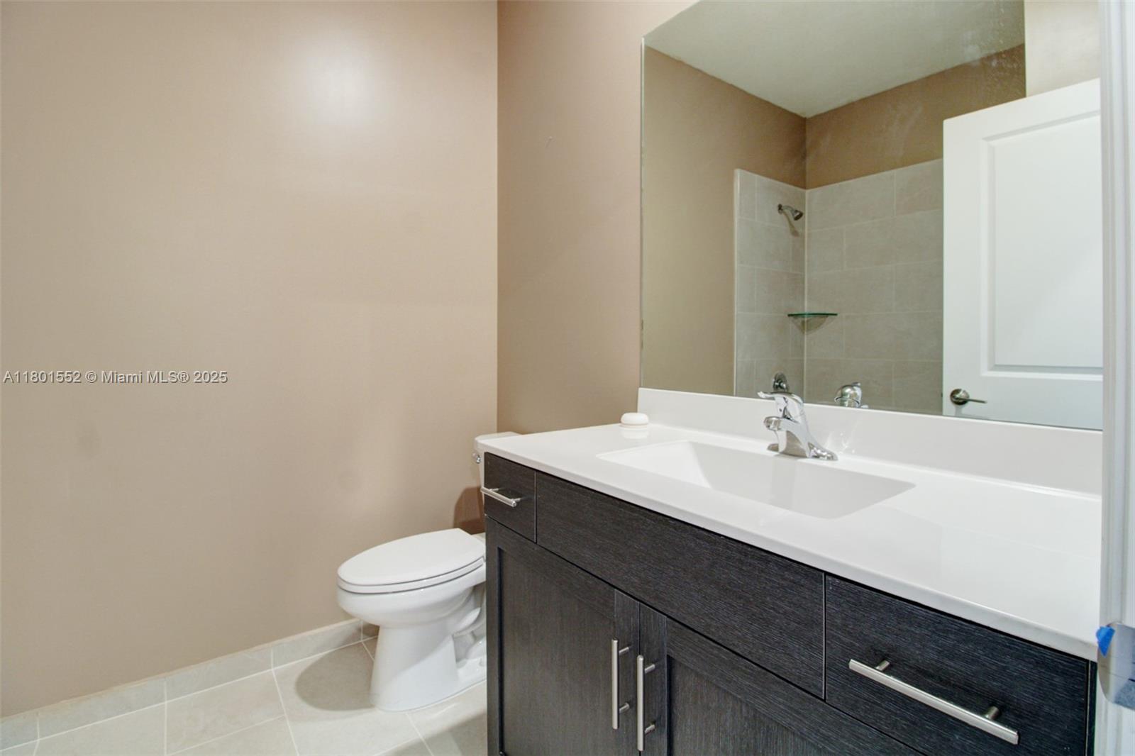 11094 West 33rd Way Hialeah, FL 33018 - Photo 32 of 46 a bathroom with a sink a toilet a mirror and vanity