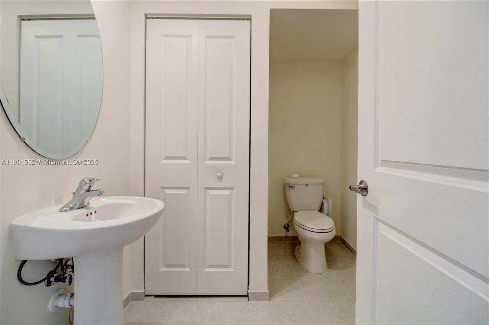 11094 West 33rd Way Hialeah, FL 33018 - Photo 9 of 46 a bathroom with a sink a toilet and a mirror