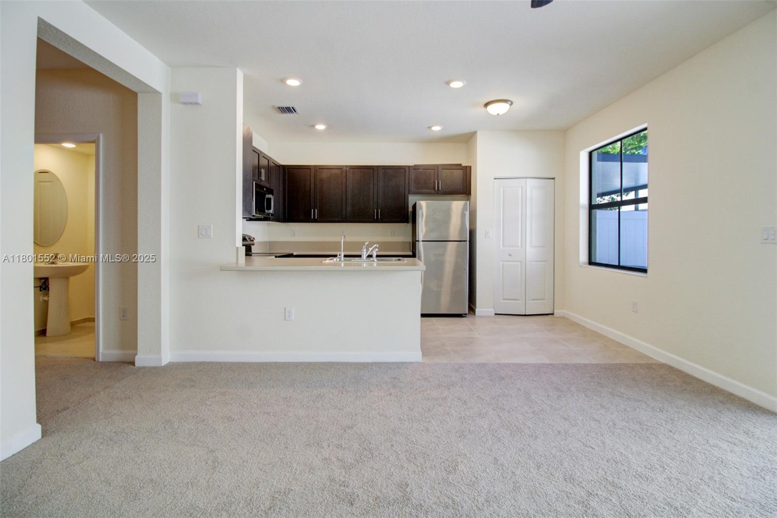 11094 West 33rd Way Hialeah, FL 33018 - Photo 10 of 46 a view of kitchen with stainless steel appliances kitchen island granite countertop a refrigerator oven a sink and dishwasher