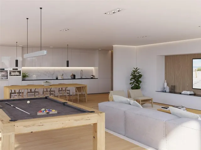 a living room with furniture and potted plants