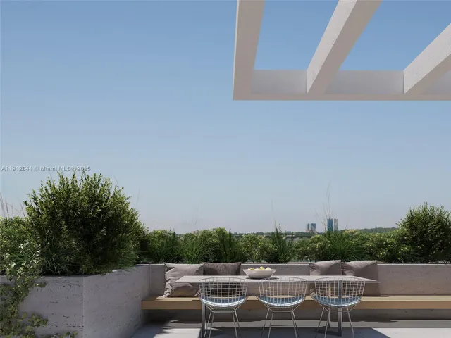 a view of yard with seating area and trees in the background