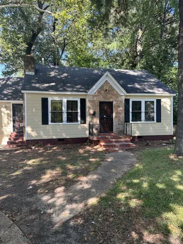 a front view of a house with a garden