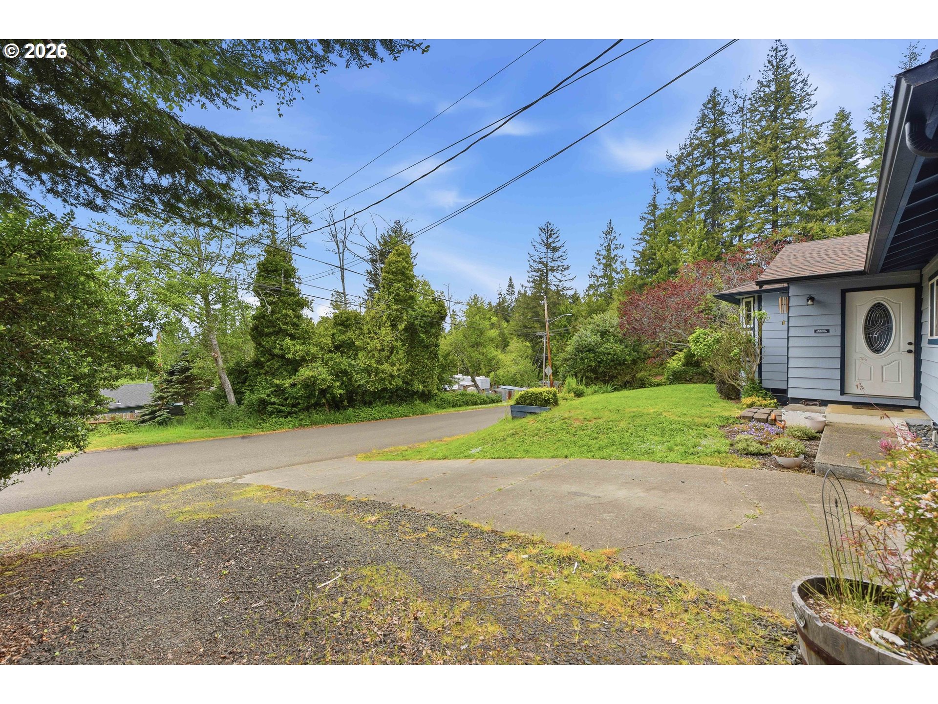 192 North Wood Ridge Road Coquille, OR 97423 - Photo 42 of 42 a view of a backyard with large trees